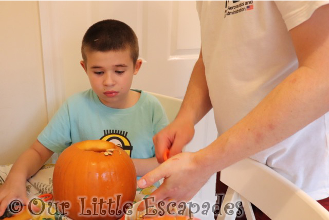 ethan darren scooping out pumpkin insides carving pumpkins