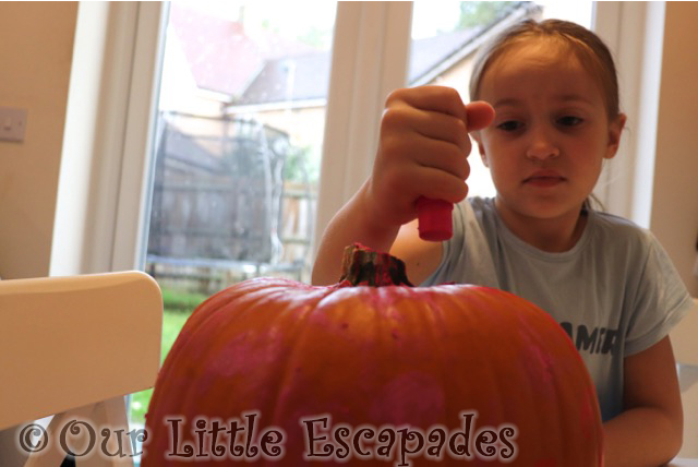 little e painting pumpkin paint sticks