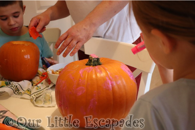 little e painting pumpkin