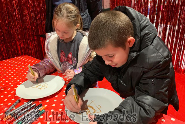 ethan little e decorating christmas plates santas grotto fenwick