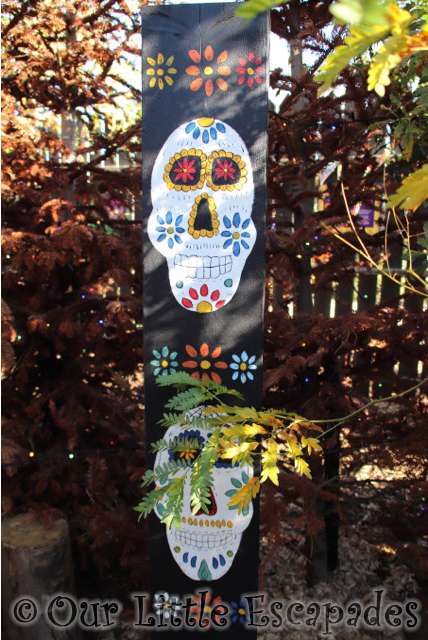 decorated day of the dead skulls painted post
