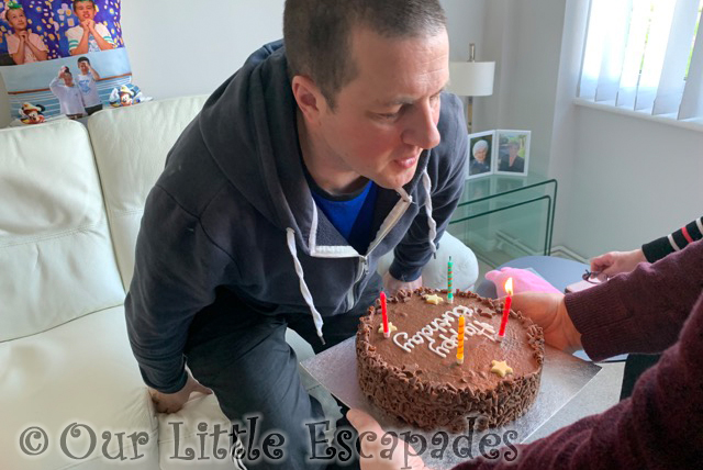 darren blowing out candles chocolate birthday cake