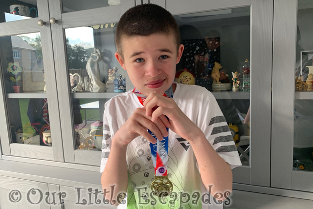 ethan holding coronation swimming medal project 365 2023