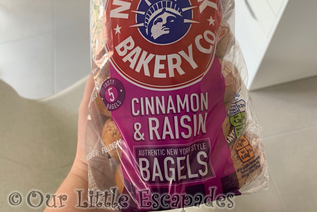 janes hand holding cinnamon raisin bagel pack