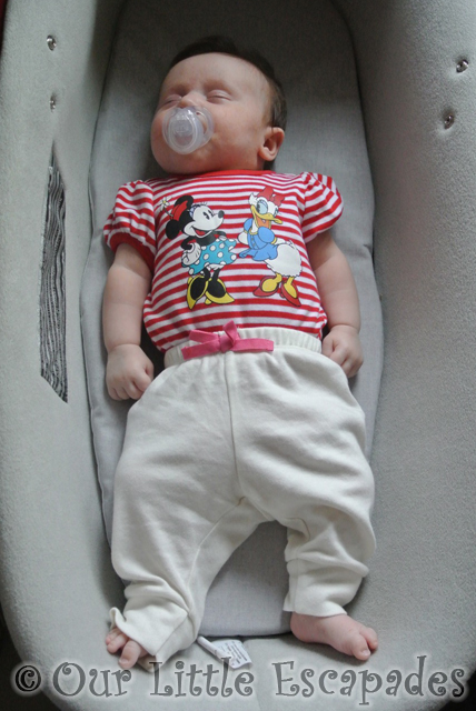 little e asleep pram straight arms legs 8 weeks old