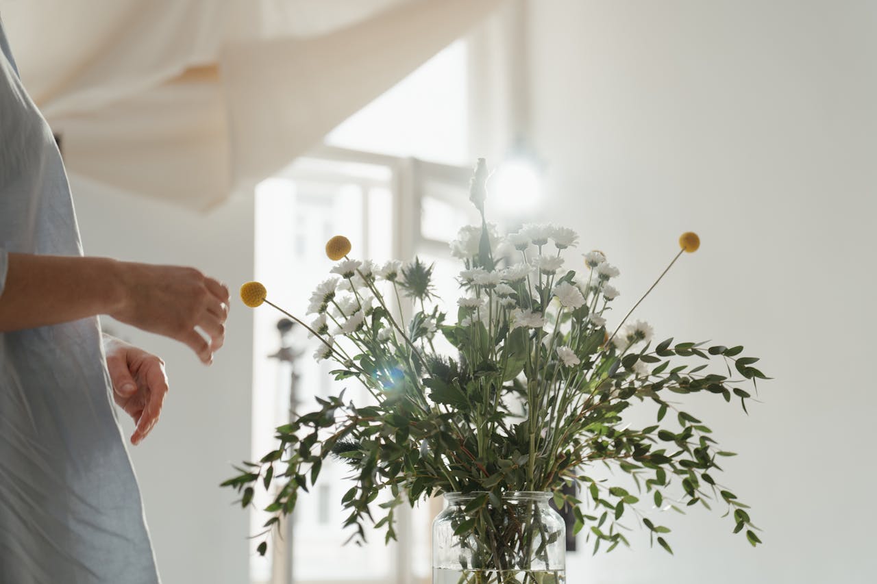 person holding white flower bouquet Flowers in Healing